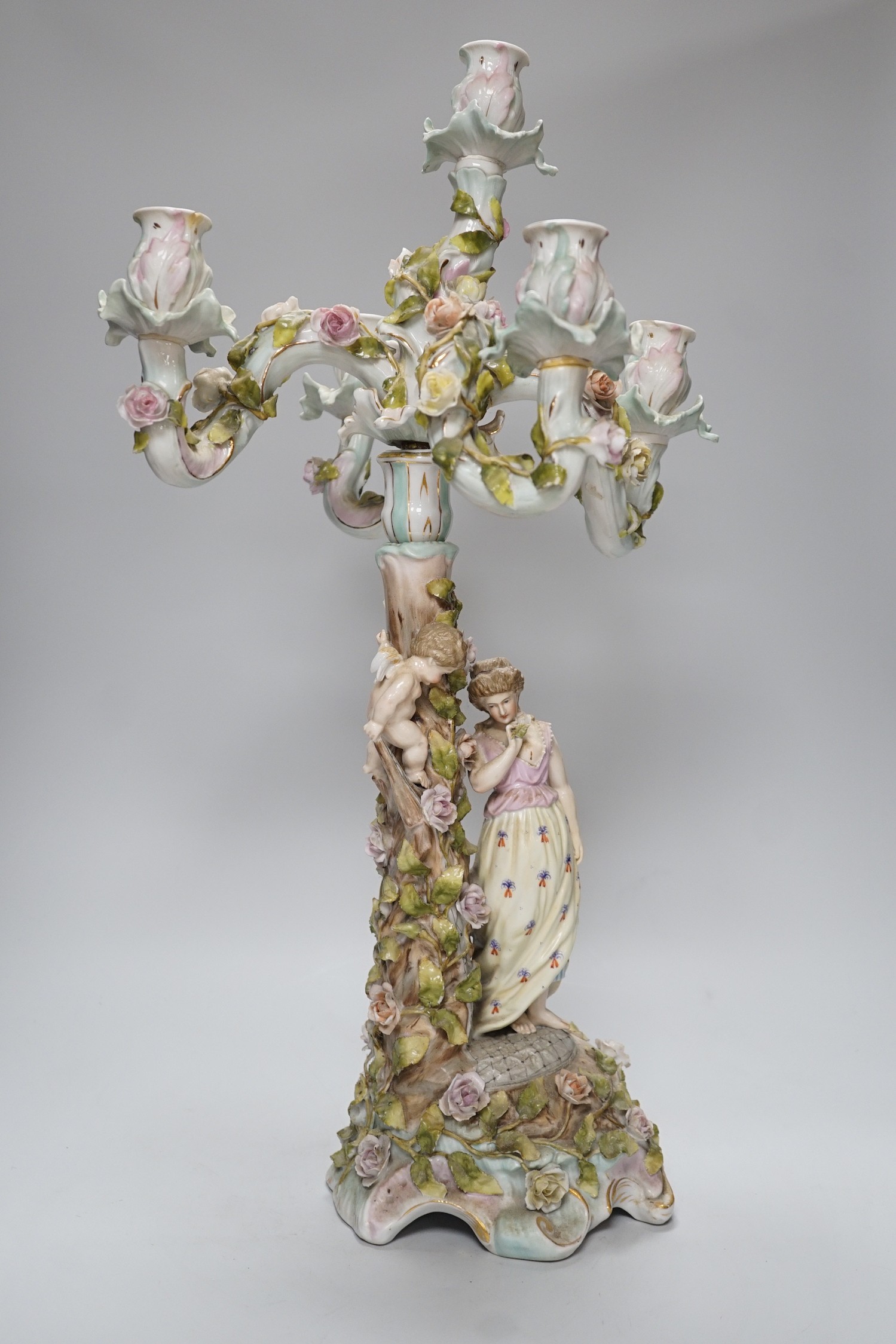 A Sitzendorf-style floral encrusted 4 branch candelabra, 57cms high